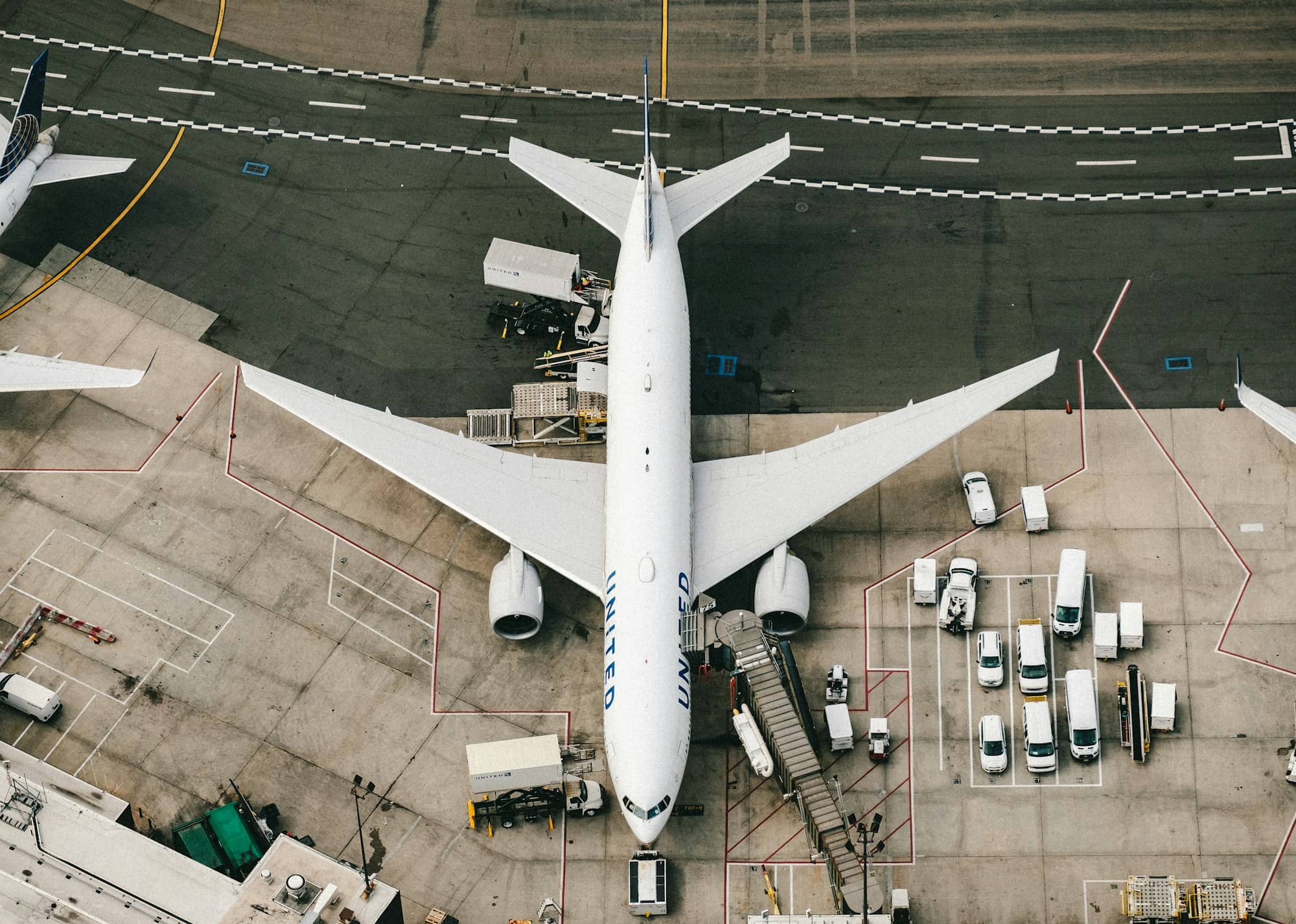 An aerial view of a plane at an airport gate